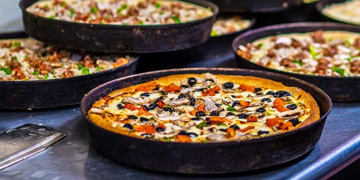 Spread of specialty pizzas served at Chicago Connection pizza parlor and Italian restaurant in Idaho